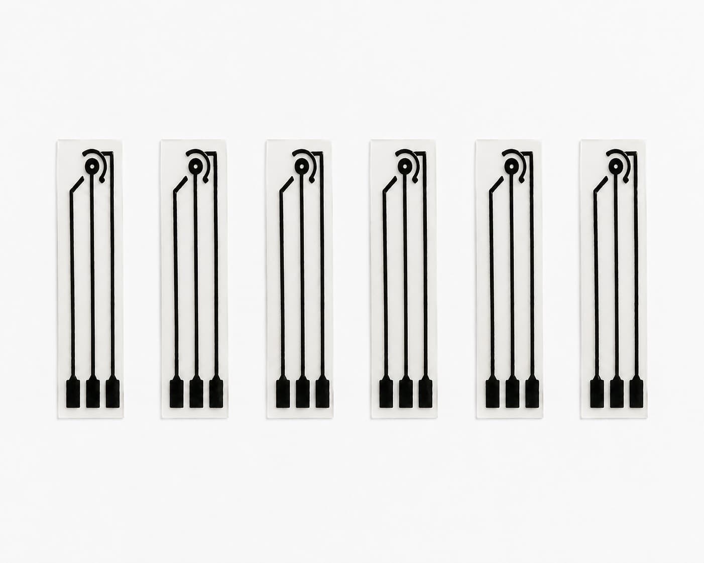 Six carbon-printed electrochemical sensor strips arranged on a white background